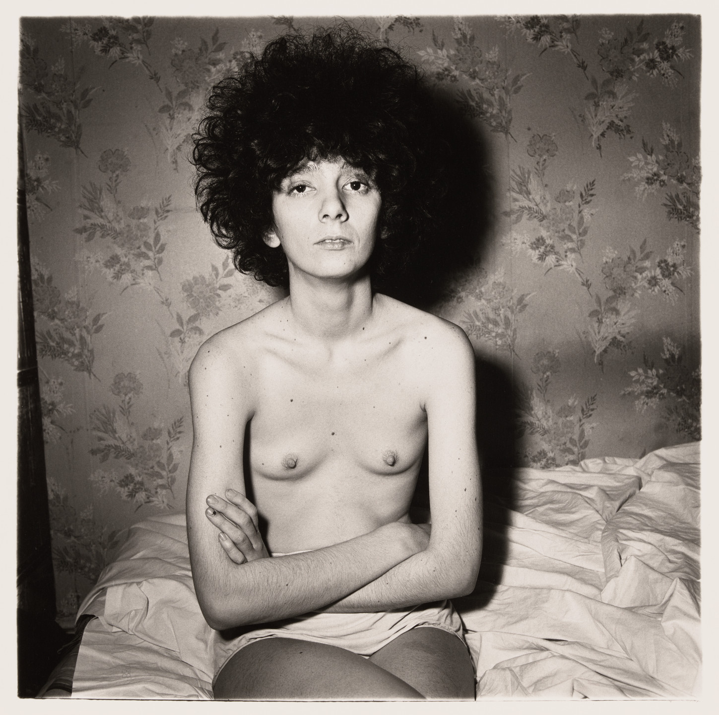 Diane Arbus. Girl sitting on her bed with her shirt off, N.Y.C., 1968. 1968