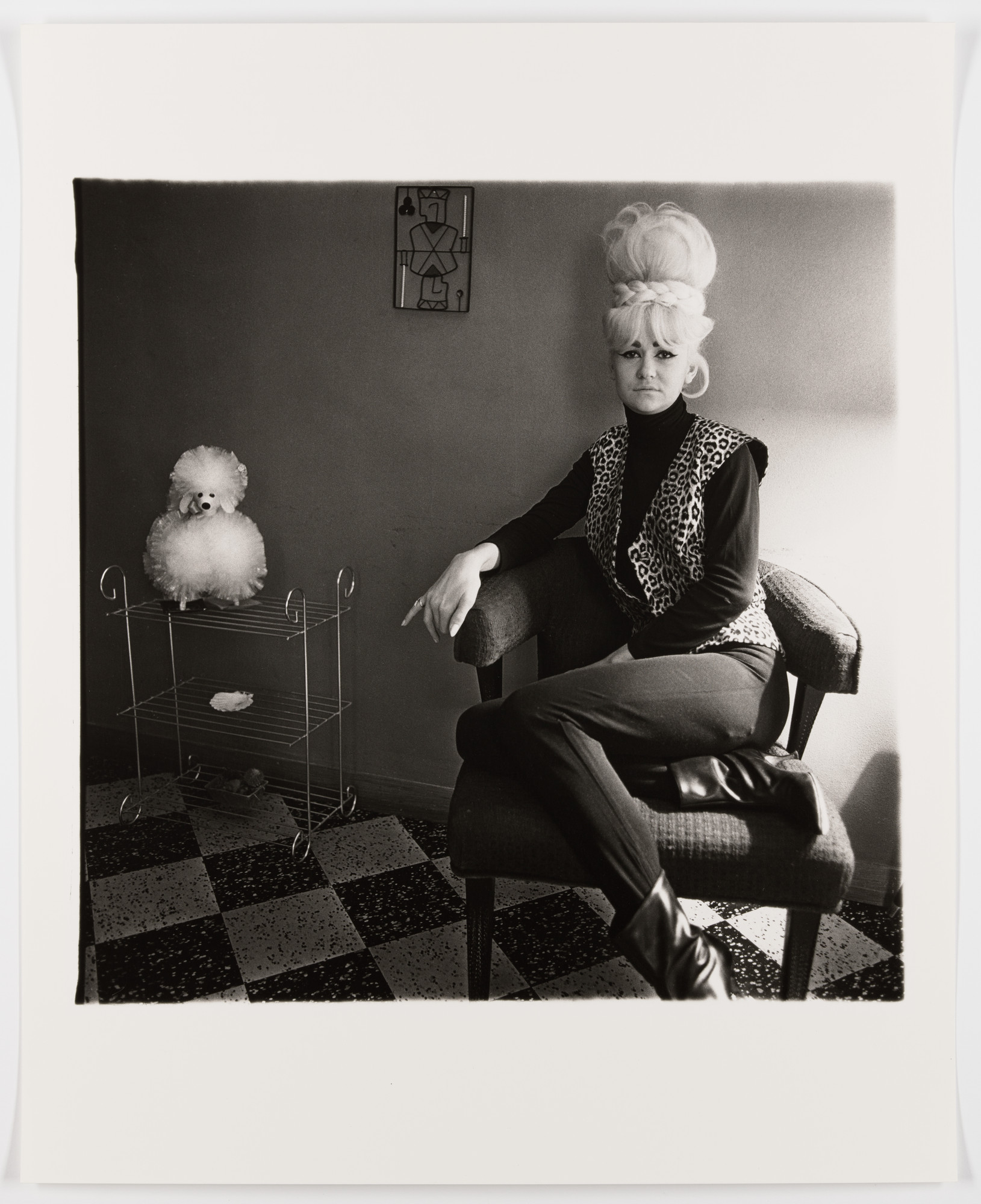 Diane Arbus. Lady bartender at home with a souvenir dog, New