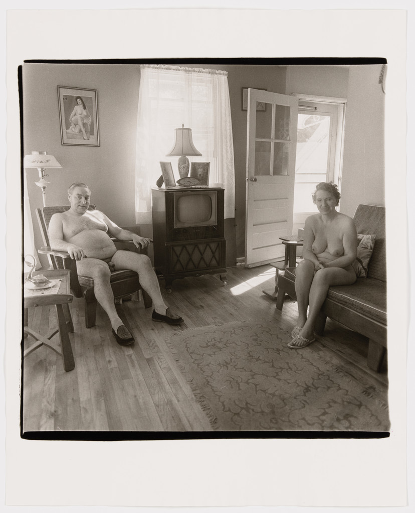 Retired man and his wife at home in a nudist camp one morning, N.J., 1963