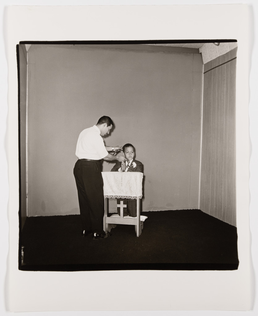 Photographer posing a boy for his Communion photograph, 1968