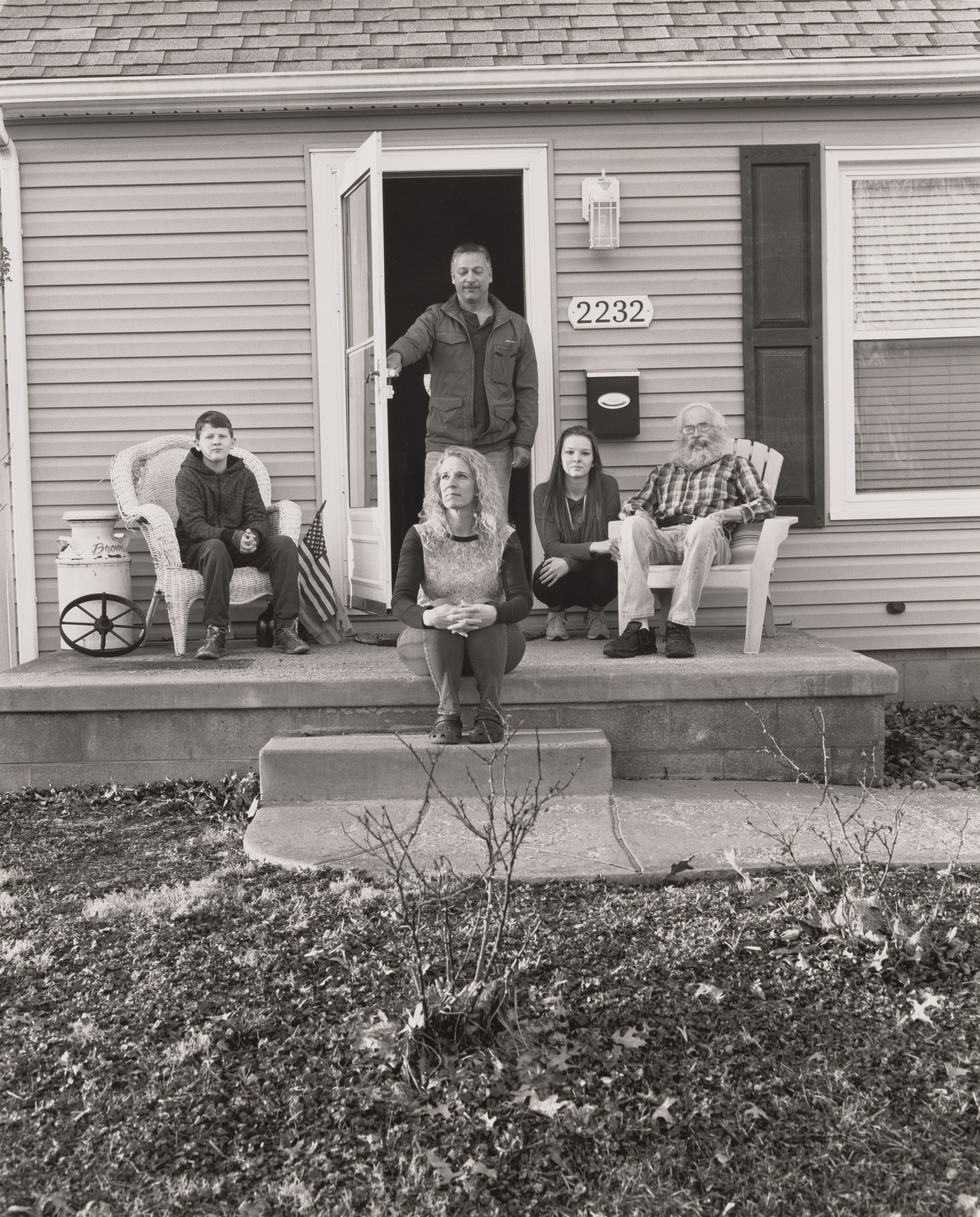 LaToya Ruby Frazier. Trisha Brown, UAW Local 1714, Women’s Committee, sitting on her front door step at home with her father Bob, her two children Mackenzie and Connor Acierno, and her boyfriend Dave Lopez, (8 years in at GM Lordstown Complex, laser braze decklid area team 23), Youngstown OH.