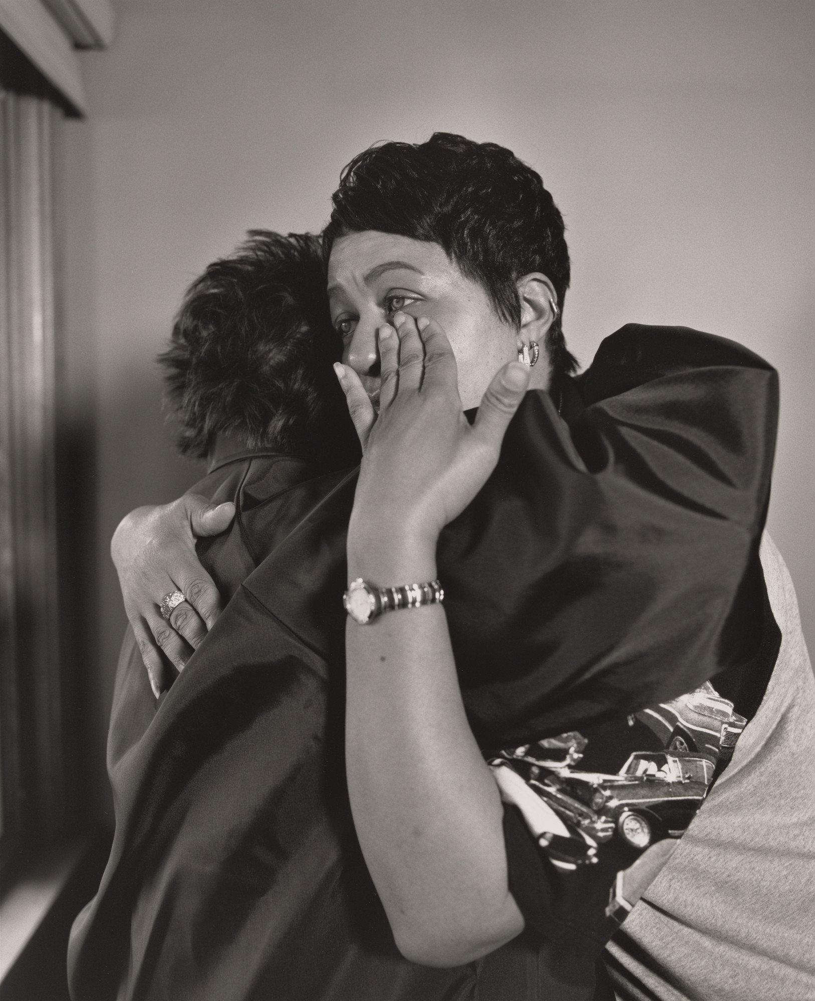 LaToya Ruby Frazier. Kesha Scales, UAW Local 1714, hugging her best friend and former co-worker Beverly Williams in her living room, (22 years in at GM Lordstown Complex, pressroom), Youngstown, OH.