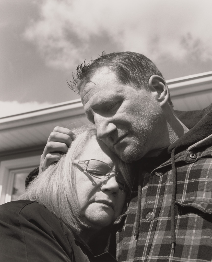 Jonathan Auckey, Jr., UAW Local 1112, holding his mother Kathleen outside their family home, (19.5 years in at GM Lord-stown Complex, body shop), Austintown, OH.