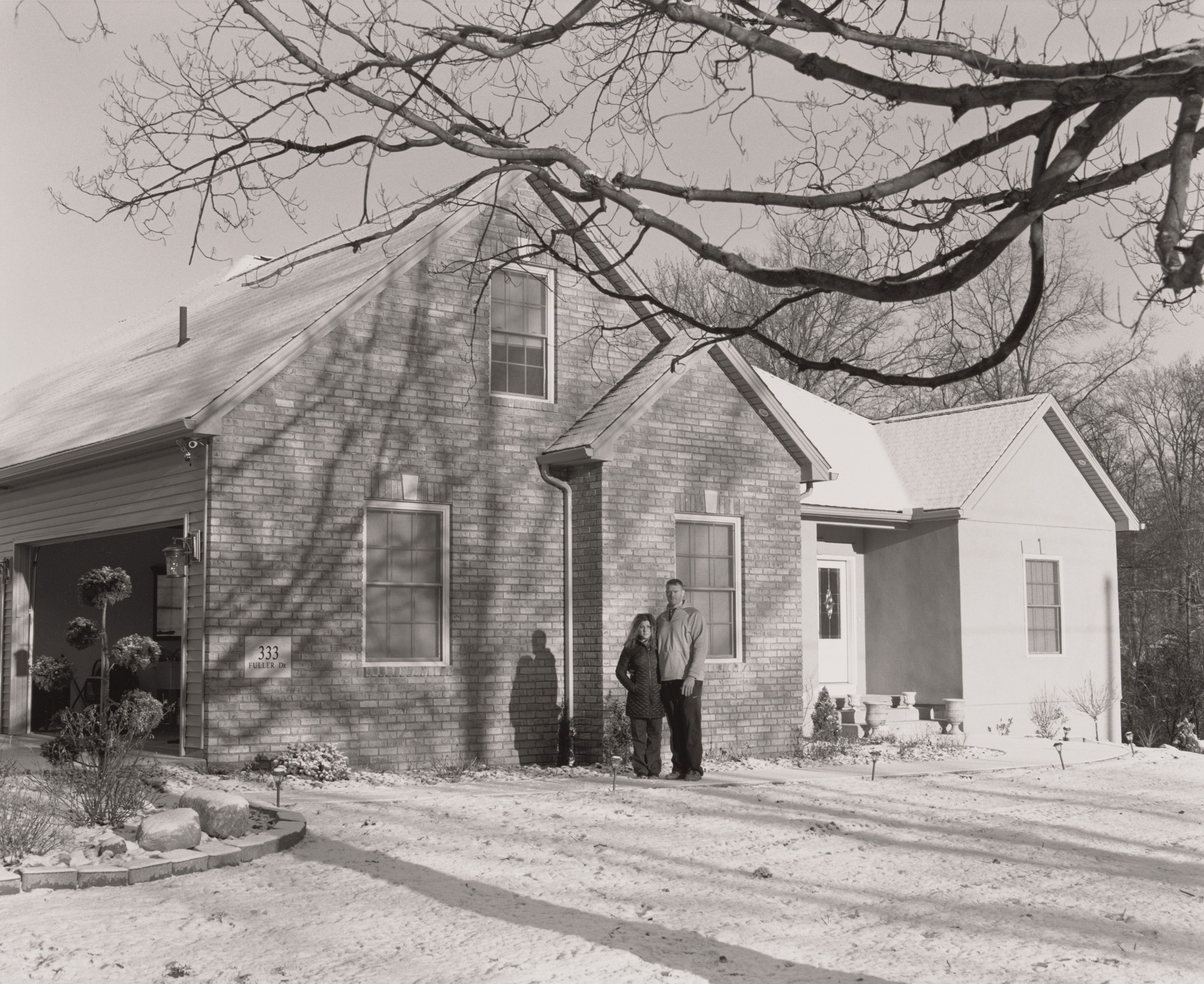 LaToya Ruby Frazier. Ernie Long, UAW Local 1714, Trustee, (11 years in at GM Lordstown Complex, Press Room team leader), with his wife Eydokia standing in front of their newly custom-built house, Highland Township, OH, 2019