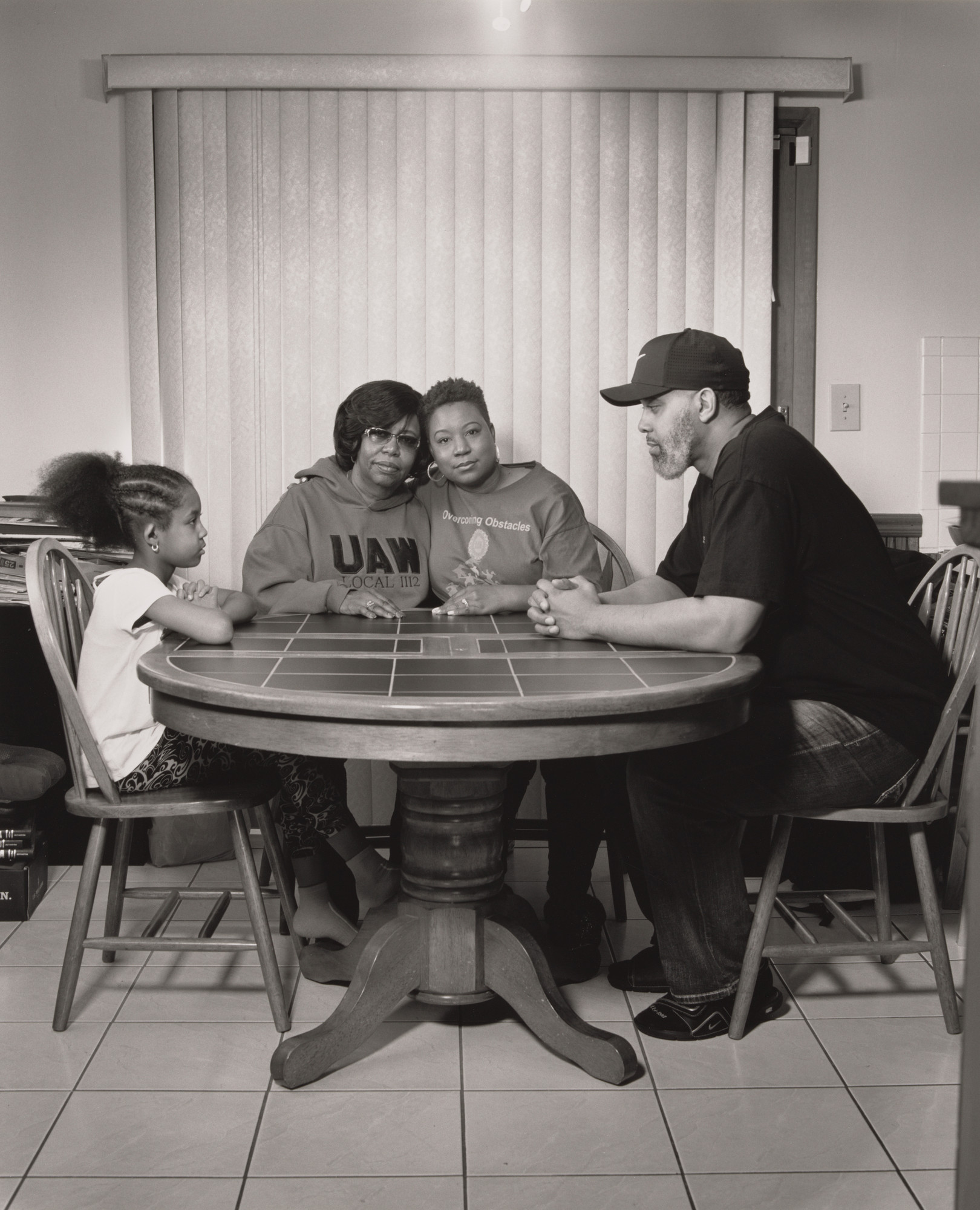 LaToya Ruby Frazier. Sherria Duncan, UAW Local 1112, at her kitchen table with her mother Waldine Arrington, her daughter Olivia, and her husband Jason, (23 years in at GM Lordstown Complex, trim and paint shop),Waldine Arrington (34 years in at GM Lordstown Complex, van plant, car plant, body shop, chassis, everywhere except paint and trim), Austintown, OH.