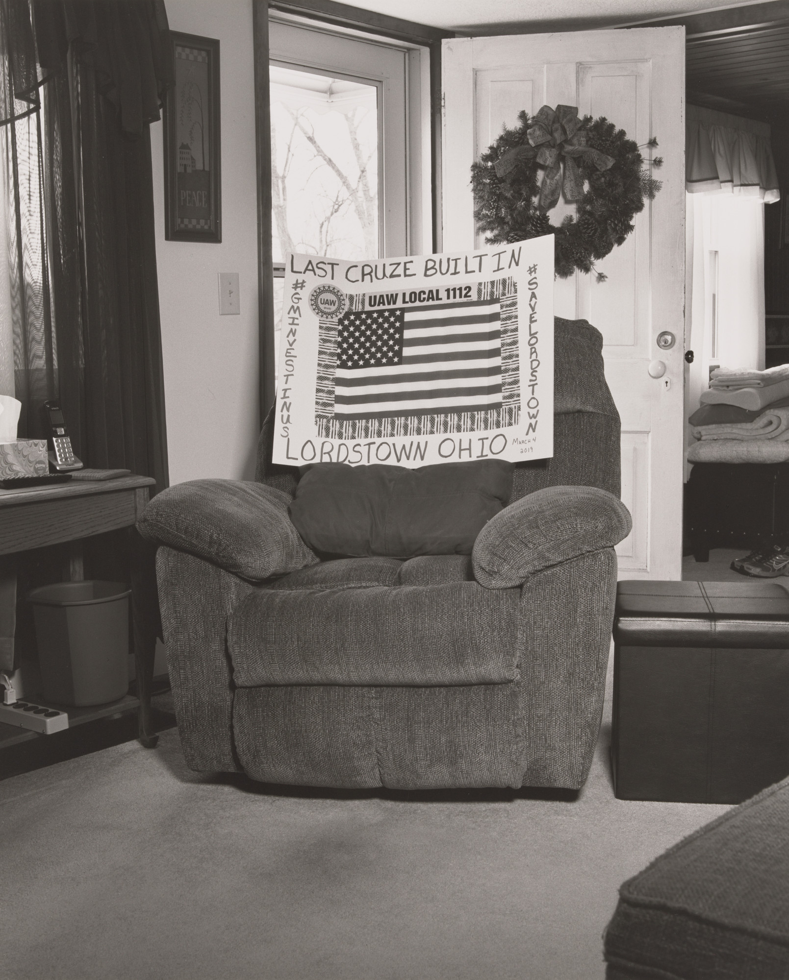 LaToya Ruby Frazier. Vickie Raymond’s mother Margie’s recliner in her living room with Vickie’s Drive-It-Home campaign sign, (24 years in at GM Lordstown Complex, trim and paint shop), East Rochester, OH.