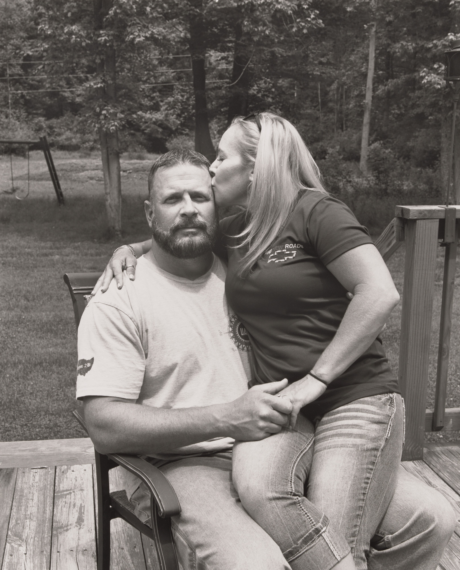 LaToya Ruby Frazier. Tawnya Morgan, UAW Local 1112, kissing her husband Dan on their back deck, (23 years in at GM Lordstown Complex, trim shop, door line team leader), Hartford, OH