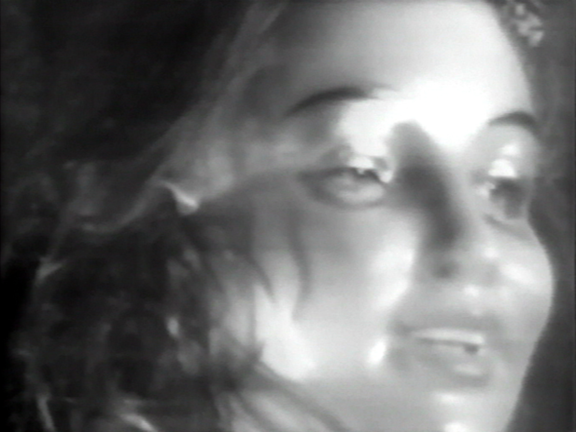 The image is a high contrast, black and white close-up of a person&#39;s face, with a slight blur effect. The person’s facial features, including eyes, nose, and slightly open mouth, are visible. This is an AI generated description. To give feedback, email ai@moma.org.