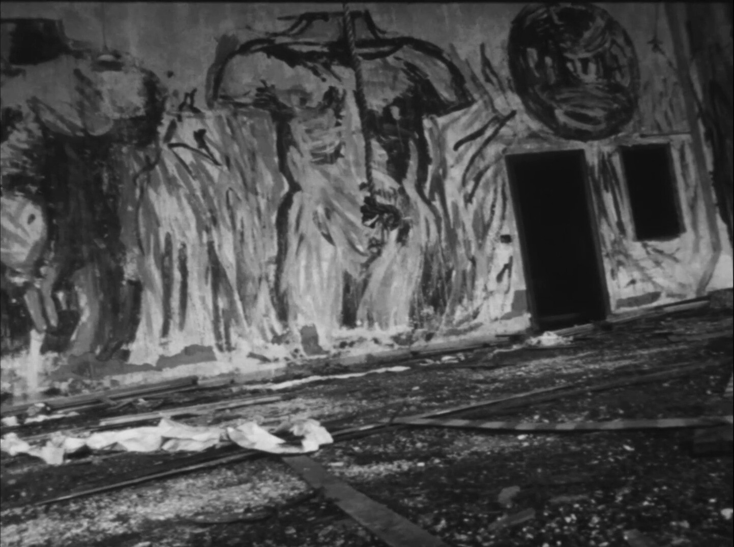 The image shows a mural painted on a wall, depicting two figures with muscular torsos and their heads tilted upwards. The predominant colors are shades of black and white, with a dark doorway and window to the right. This is an AI generated description. To give feedback, email ai@moma.org.