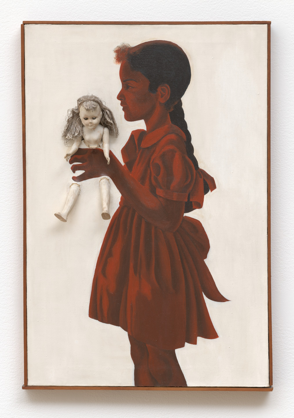 The image shows the side profile of a person in a red dress holding a white doll with gray hair against a light background. The person has dark skin and their hair is styled in a braid. This is an AI generated description. To give feedback, email ai@moma.org.