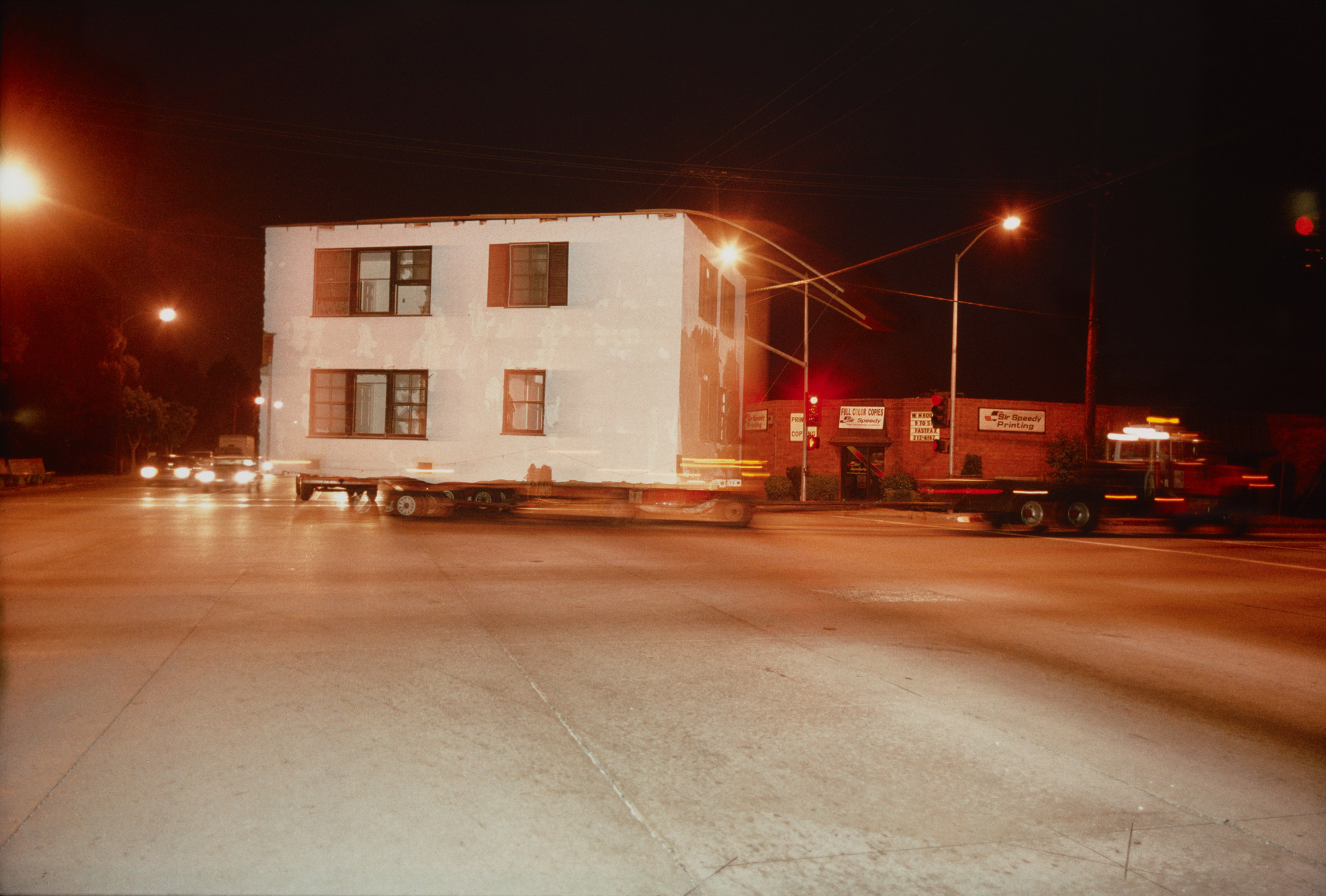 Allan Sekula. Shipyard-workers&#39; housing--built during the Second World War--being moved from San Pedro to South-Central Los Angeles from the series Fish Story. May 1990