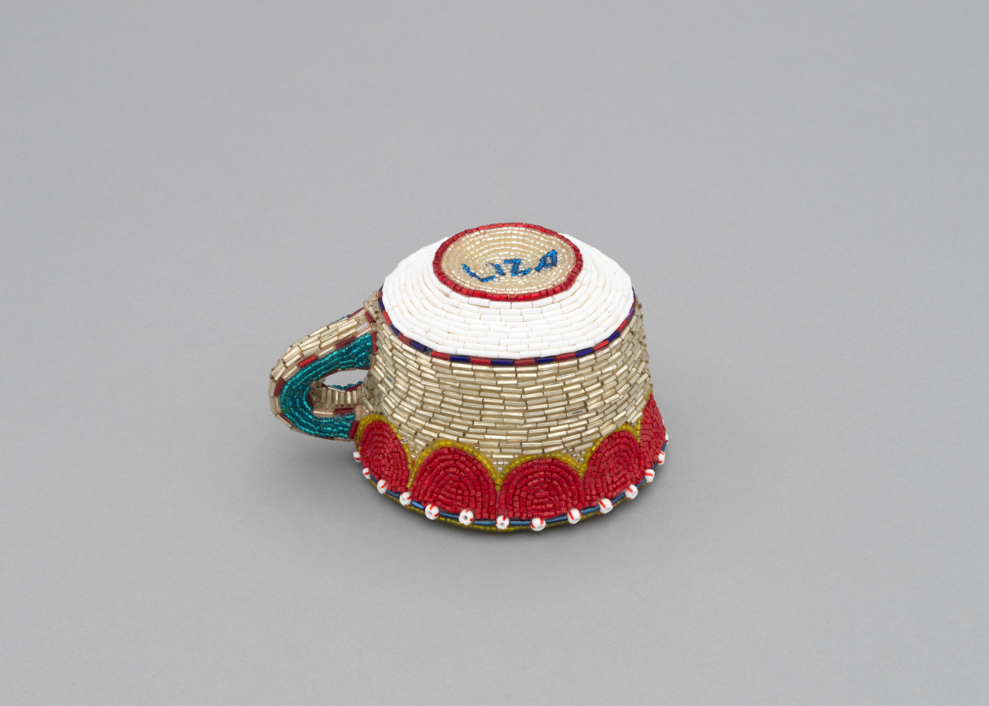 Liza Lou. Cup and Saucer. 1995