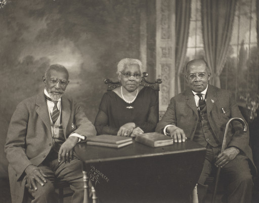 Portrait of two men and a woman