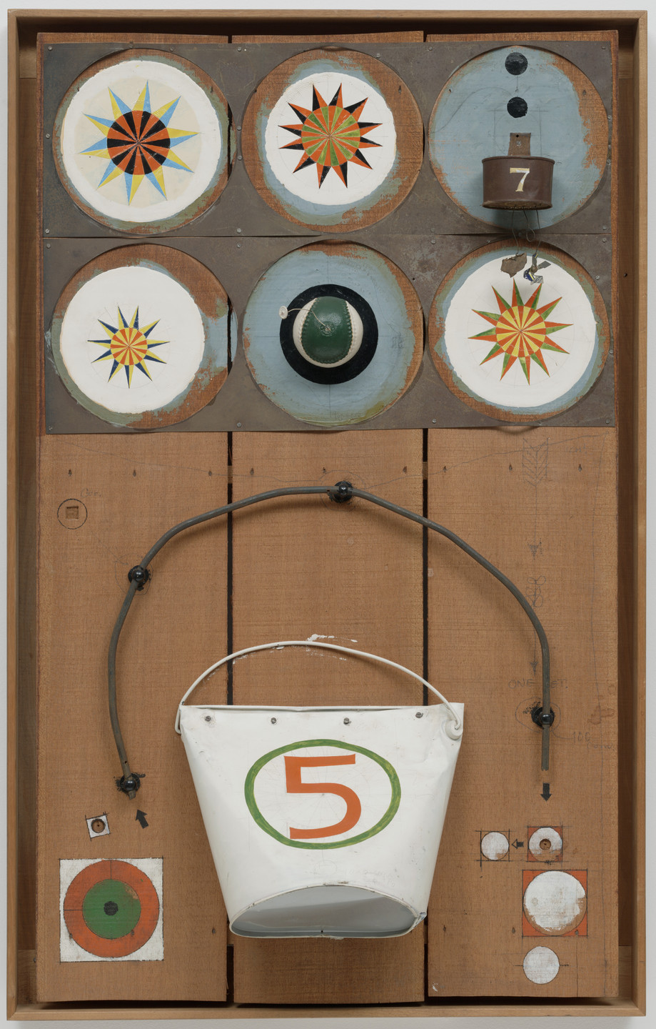 A wooden board features six circular designs with colorful starburst patterns; a small brown cup with a number 7; a green and black hat; a white bucket with a green and orange number 5. The predominant colors are brown, white, green, orange, and blue. This is an AI generated description. To give feedback, email ai@moma.org.
