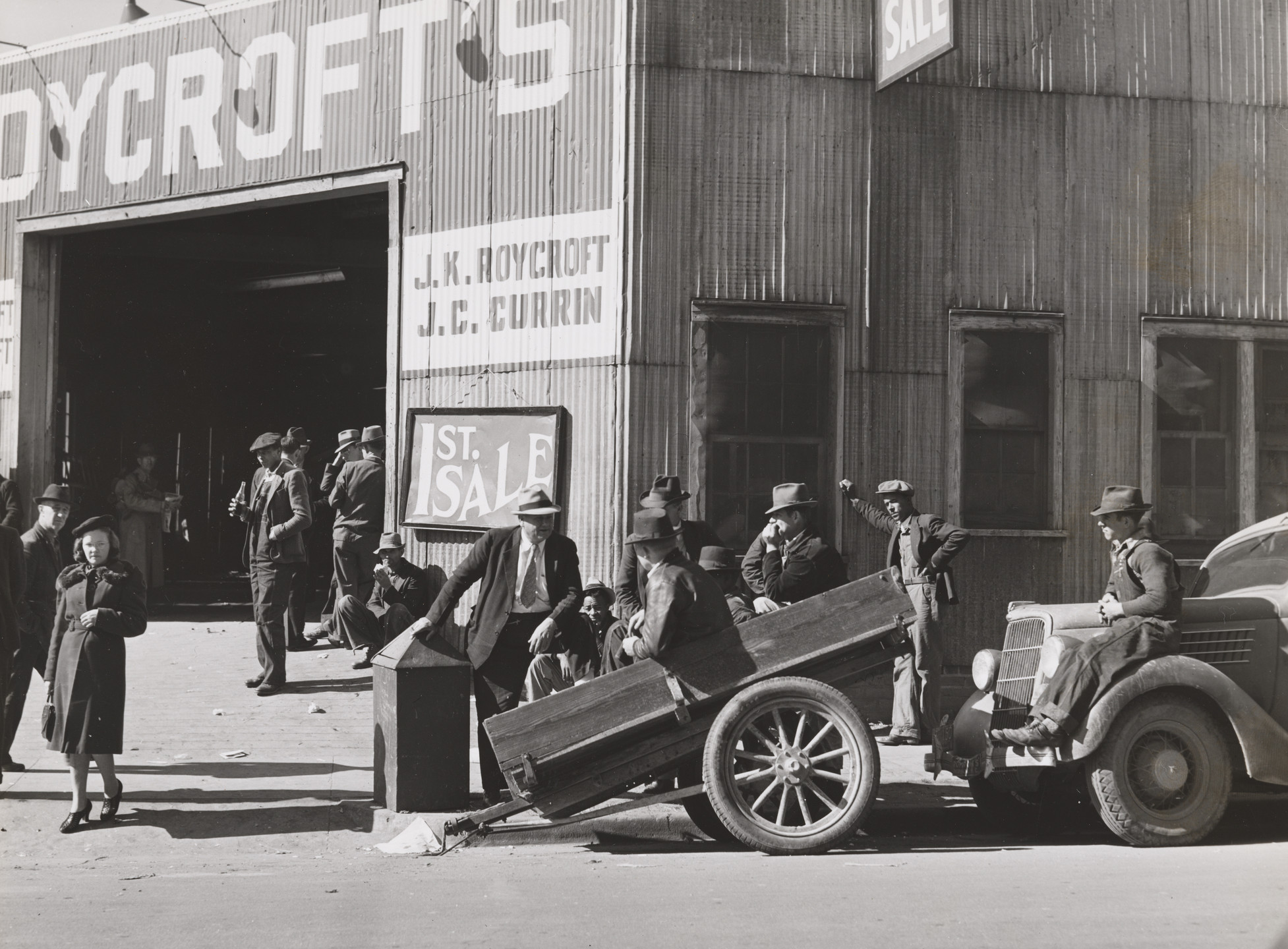 Marion Post Wolcott. Many Stories are Exchanged by Buyers and Farmers While Waiting Around Outside Warehouse During Auction Sales. Durham, North Carolina. 1939