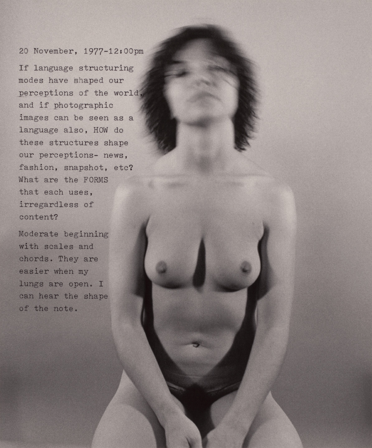 A blurred, topless figure with short dark hair sits against a gray background. To the left, text begins with &#34;20 November, 1977-12:00pm&#34; and discusses language structuring modes and perceptions. This is an AI generated description. To give feedback, email ai@moma.org.