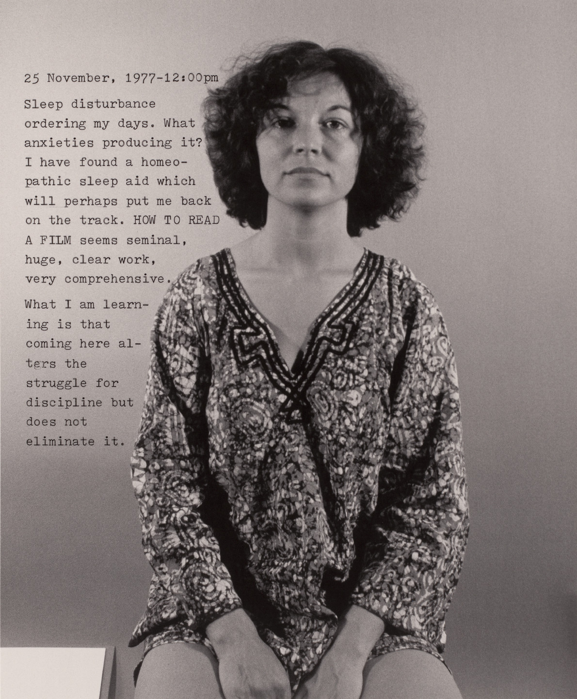 A person with curly hair sits facing the camera, wearing a patterned shirt composed mainly of black and white colors. To the left, text discusses a date, sleep disturbance, and experiences with learning. This is an AI generated description. To give feedback, email ai@moma.org.