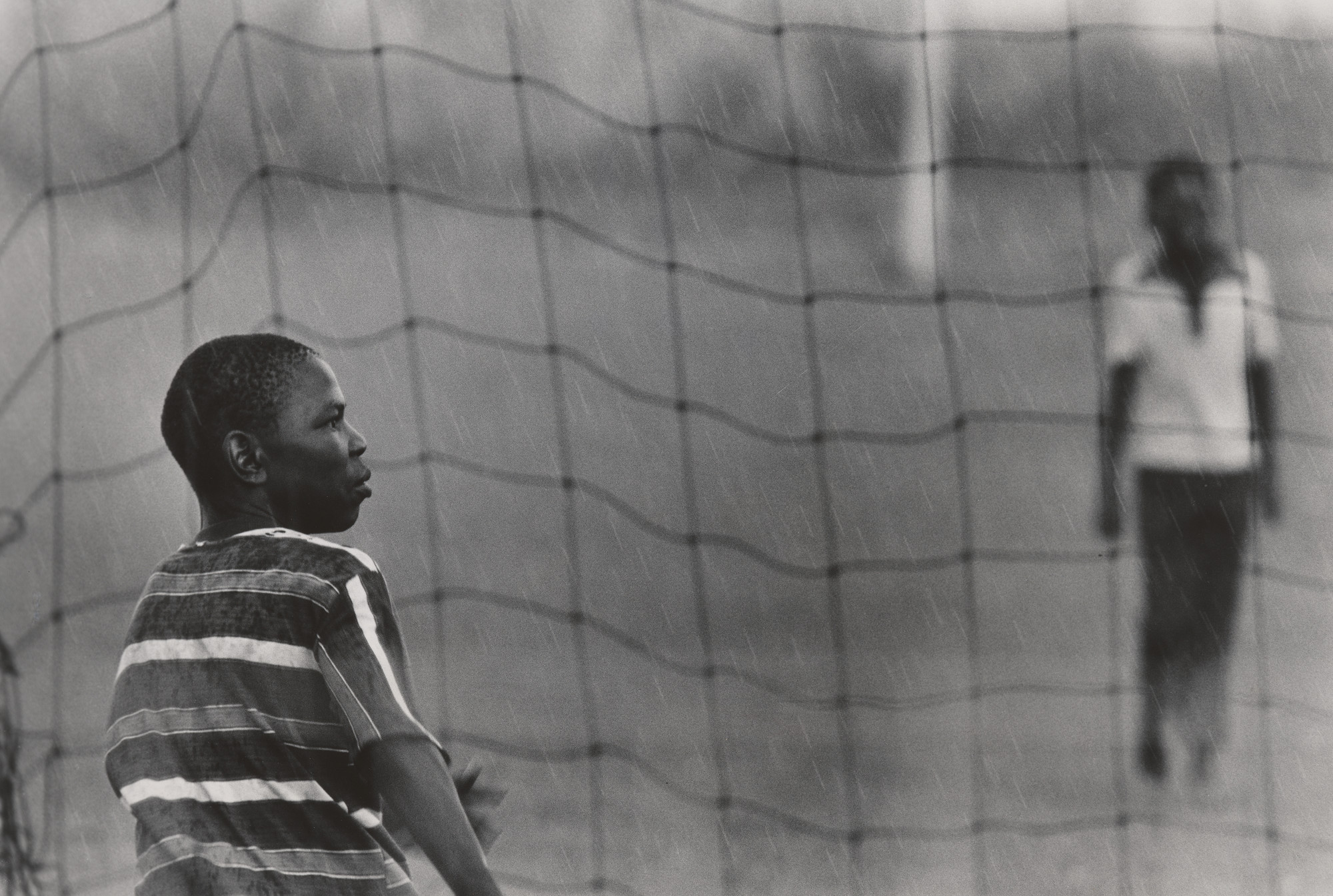 Jeanne Moutoussamy-Ashe. Soccer Players in the Rain, Soweto, South Africa. 1978
