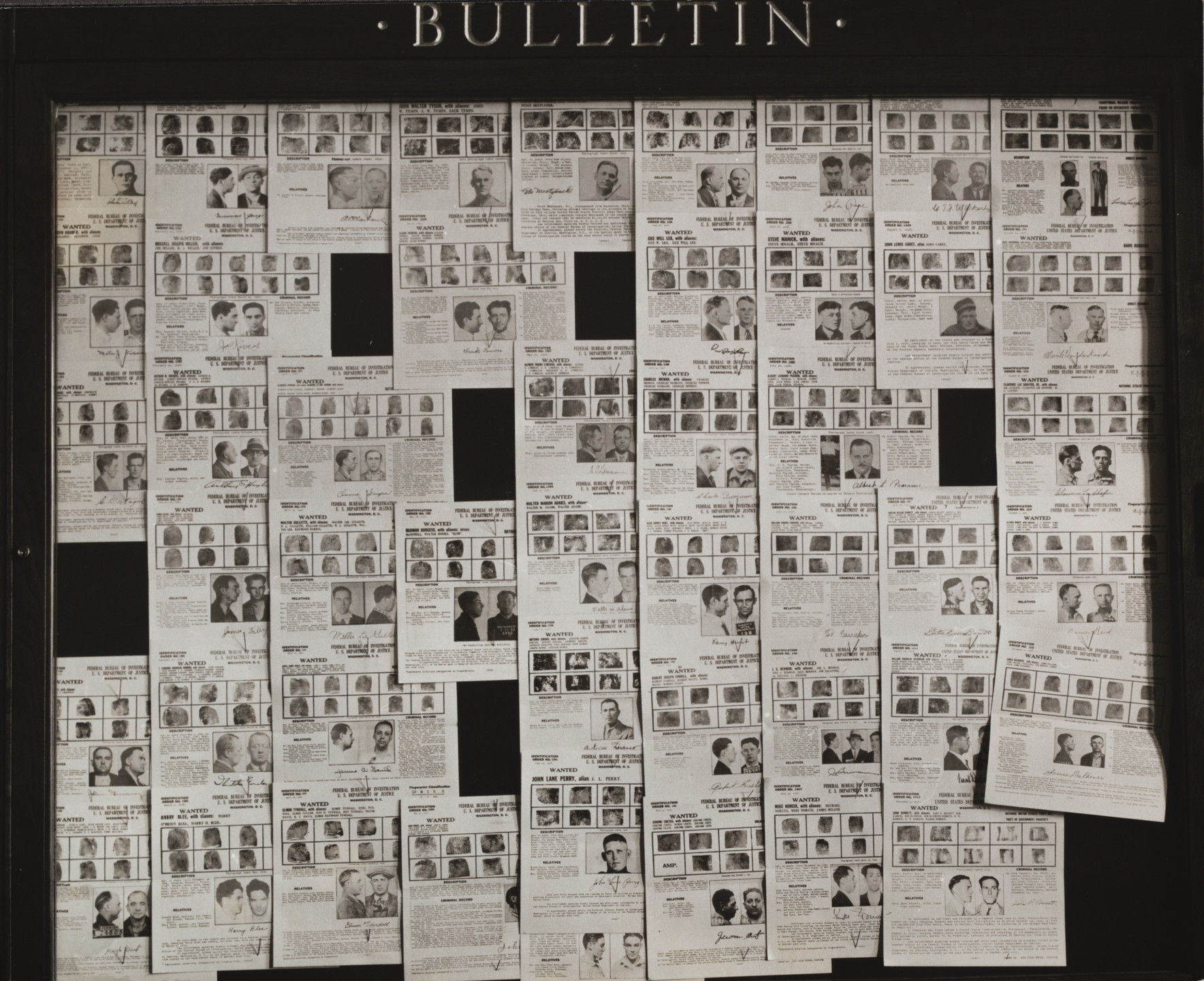 Russell Lee. Bulletin Board in Post Office Showing a Large Collection of &#34;Wanted Men&#34; Signs, Ames, Iowa. November 1936