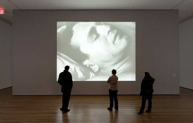 Installation view of Andy Warhol: Motion Pictures at The Museum of Modern Art, 2010. Sleep (1963). ©2010 The Andy Warhol Museum, Pittsburgh, PA, a museum of Carnegie Institute. All rights reserved. Photo: Jason Mandella