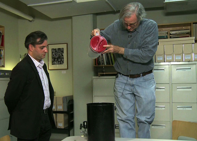 John Hendricks, with instructor Pablo Helguera, pouring water according to a Fluxus score