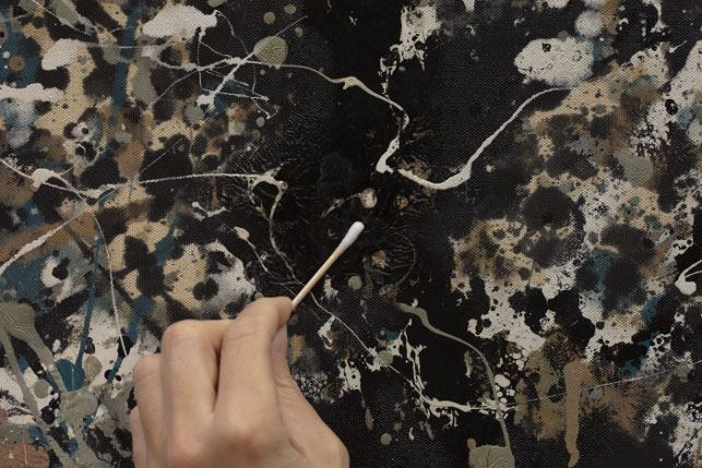 Testing solvents for overpaint removal by applying a small amount of solvent to an area of restoration