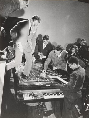 Philip Corner with Emmett Williams, George Maciunas, Benjamin Patterson, Dick Higgins, and Alison Knowles. Piano Activities, performed during Fluxus Internationale Festpiele Neuester Musik, Hörsaal des Städtischen Museums, Wiesbaden, Germany, September 1, 1962. Gelatin silver print, 8 1/4 x 6 5/16" (20.9 x 16 cm). Original photographer: Deutsche Presse Agentur. The Gilbert and Lila Silverman Fluxus Collection Gift. Photo: Peter Butler