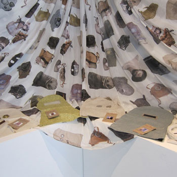 Allison Smith’s masks from her Needle Work project, as featured at MoMA Studio: Breathe with Me, with her printed parachute in the background. Photo by Sarah Kennedy