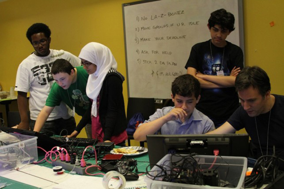 The class finalizing the computers and games for the show