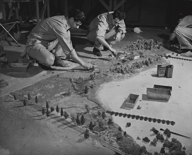 "Three model makers at work on the River Crossing Village" during exhibition. Exhibition Dates: January 26, 1944 through March 5, 1944. Photographic Archive. The Museum of Modern Art Archives, New York. Photographer unknown
