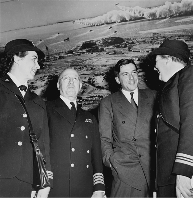 From left: "Lt. Comm. Eleanor Grant Rigby, Commander of Seamen WAVES, Capt. S. C. Loomis, Andrew Heiskell of Life Magazine, Ltd. Comm. Elizabeth Crandall, District Director of The WAVES" at the opening of the exhibition. Exhibition Dates: January 26, 1944 through March 5, 1944. Photographic Archive. The Museum of Modern Art Archives, New York. Photographer, J. R. Eyerman