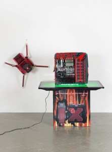 Simon Denny. Berlin Startup Case Mod: Rocket Internet. 2014. Custom computer case, packaging, heavy-duty computer hardware, digital prints on Plexiglas, custom Plexiglas components, metal fittings, Samsung UE40F6500 SS, video on USB stick, and custom spider computer case, 42 1/8 x 36 5/8 x 21 5/8" (107 x 93 x 55 cm) and 30 11/16 x 31 1/2 x 12 3/16" (78 x 80 x 31 cm). The Museum of Modern Art, New York. Fund for the Twenty-First Century. Photograph by galerie