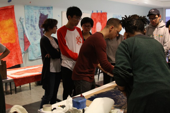Artist Yashua Klos oversees another printmaking project