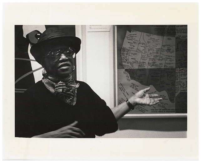 Artist Faith Ringgold speaking in front of her work, United States of Attica (1972), for the Gallery Talks By Artists series which formed part of the week-long Contemporary Art in Context program, March 4, 1988. Museum-Related Photographs, 213. MoMA Archives, NY